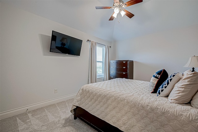 carpeted bedroom with vaulted ceiling and ceiling fan