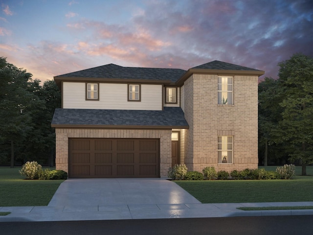 view of front of property featuring a garage and a yard