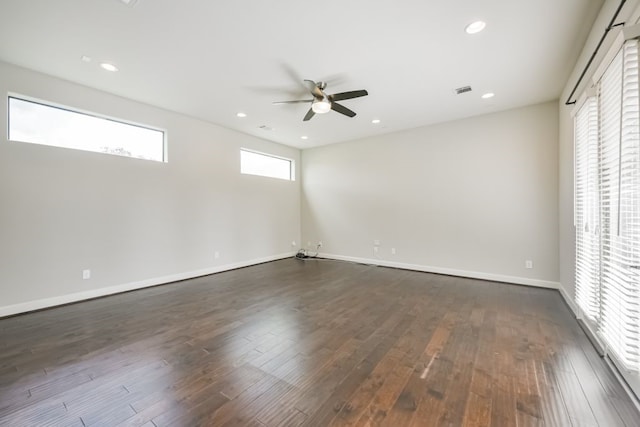 empty room with dark hardwood / wood-style floors and ceiling fan