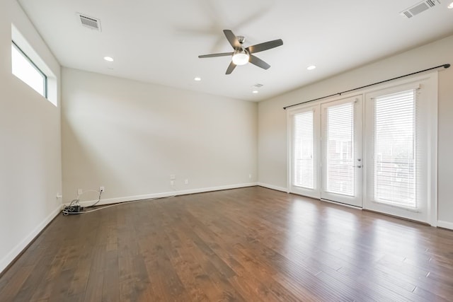 spare room with ceiling fan, dark hardwood / wood-style flooring, and french doors