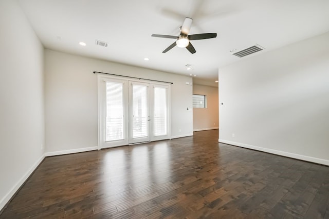 empty room featuring ceiling fan, dark hardwood / wood-style flooring, and french doors