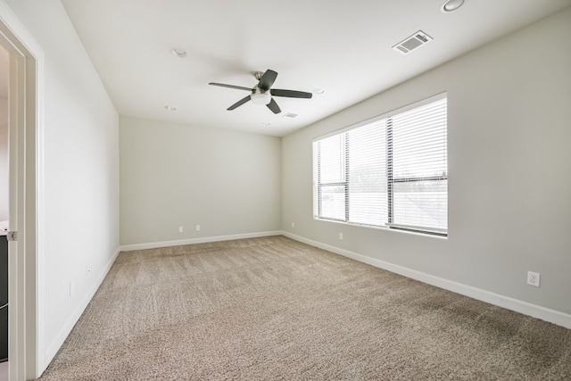 spare room with carpet flooring and ceiling fan