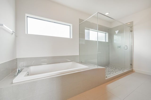 bathroom featuring tile patterned floors and shower with separate bathtub