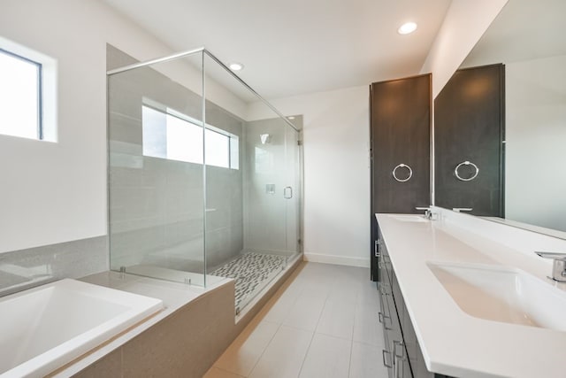 bathroom featuring tile patterned flooring, vanity, and shower with separate bathtub