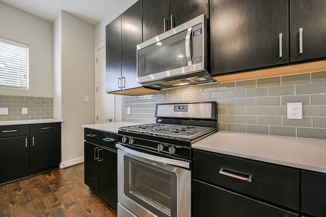 kitchen featuring tasteful backsplash, dark hardwood / wood-style flooring, and stainless steel appliances