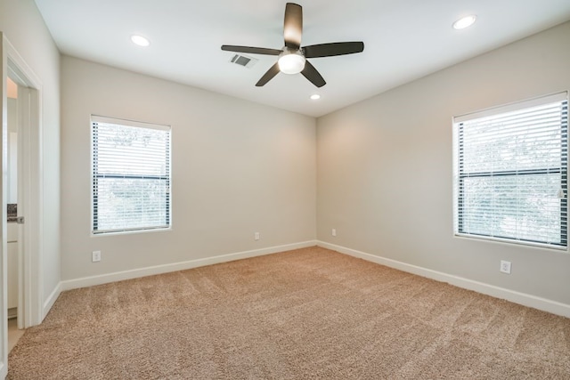 carpeted empty room featuring ceiling fan