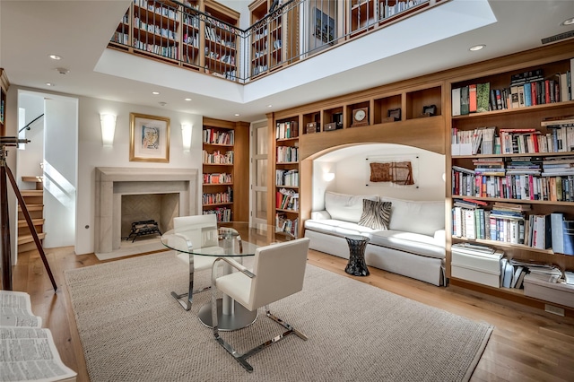 living area featuring a high ceiling and light wood-type flooring