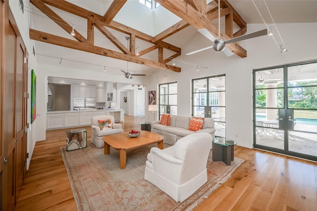 living room featuring ceiling fan, beam ceiling, high vaulted ceiling, and french doors