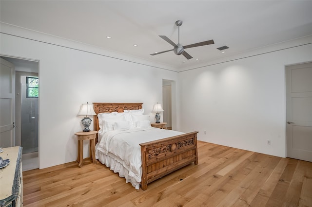 bedroom featuring light hardwood / wood-style flooring, ceiling fan, and ornamental molding