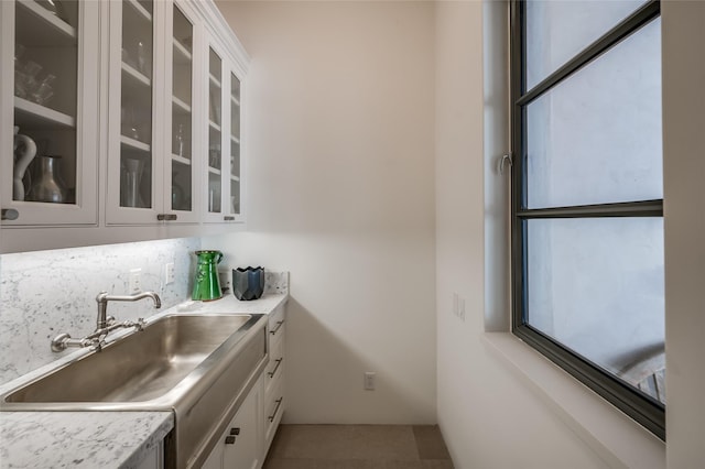 kitchen featuring sink and white cabinets