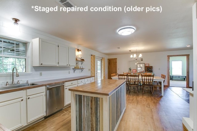 kitchen featuring white cabinetry, a kitchen island, butcher block countertops, and dishwasher