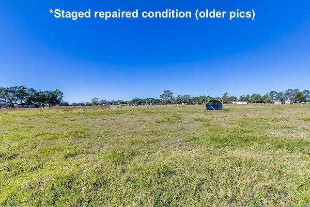 view of yard with a rural view