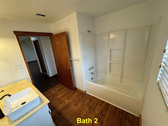 bathroom with vanity, tub / shower combination, and wood-type flooring