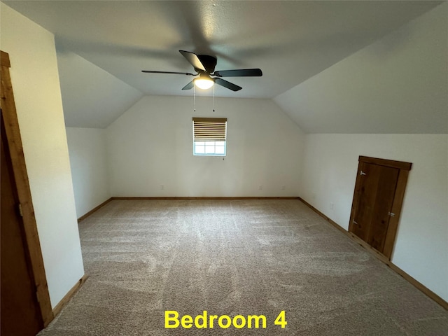 bonus room with lofted ceiling, ceiling fan, baseboards, and carpet flooring