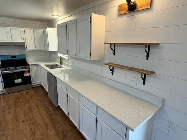 kitchen with a sink, white cabinetry, appliances with stainless steel finishes, dark wood-style floors, and open shelves