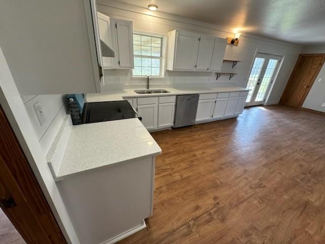 kitchen with dark wood-style flooring, light countertops, black range with electric stovetop, stainless steel dishwasher, and a sink