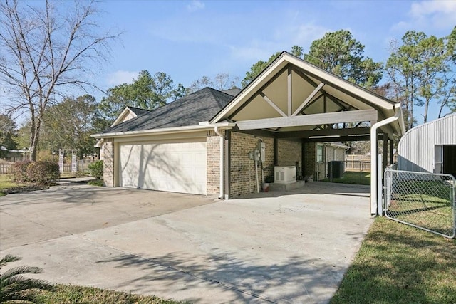 view of front of house with ac unit, a garage, and a carport