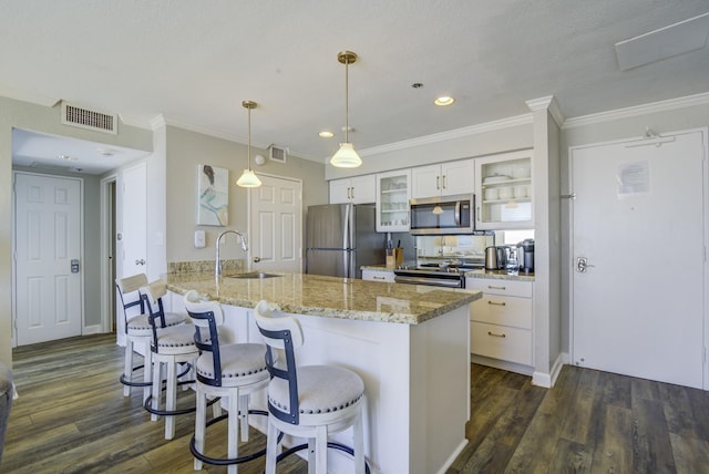 kitchen featuring pendant lighting, white cabinets, sink, kitchen peninsula, and stainless steel appliances