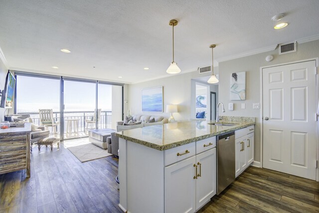 kitchen featuring dishwasher, a wall of windows, sink, light stone counters, and white cabinetry