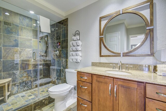 bathroom with crown molding, vanity, a shower with shower door, and toilet