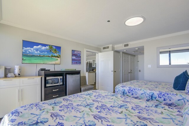 bedroom featuring fridge and ornamental molding