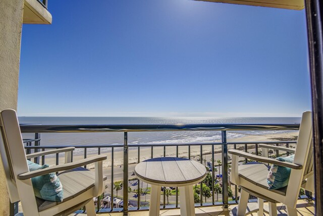 balcony with a beach view and a water view