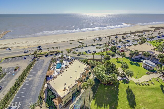 birds eye view of property with a water view and a beach view