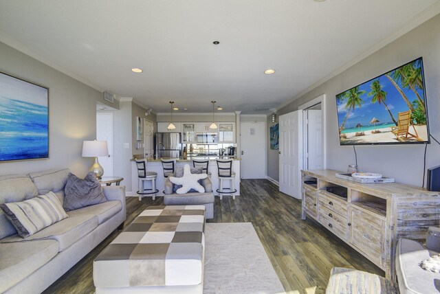 living room with dark hardwood / wood-style floors and crown molding