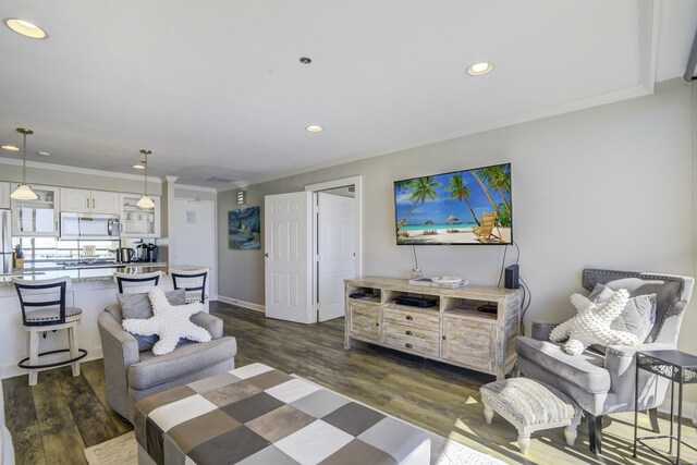 living room with dark hardwood / wood-style floors and ornamental molding