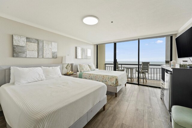 5220 Seawall Blvd Unit 1536/37, Galveston, TX 77551 - bedroom featuring crown molding, light wood-type flooring, and access to outside