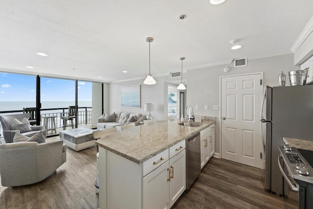 5220 Seawall Blvd Unit 1536/37, Galveston, TX 77551 - kitchen featuring appliances with stainless steel finishes, a peninsula, open floor plan, dark wood-style flooring, and ornamental molding
