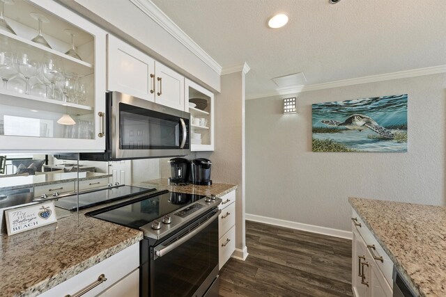5220 Seawall Blvd Unit 1536/37, Galveston, TX 77551 - kitchen with stainless steel appliances, crown molding, dark wood-type flooring, a textured ceiling, and white cabinetry