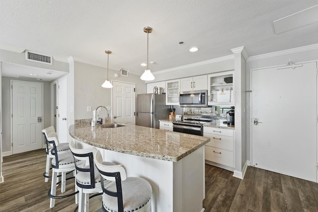5220 Seawall Blvd Unit 1536/37, Galveston, TX 77551 - kitchen with appliances with stainless steel finishes, dark wood-style flooring, a peninsula, a kitchen bar, and a textured ceiling