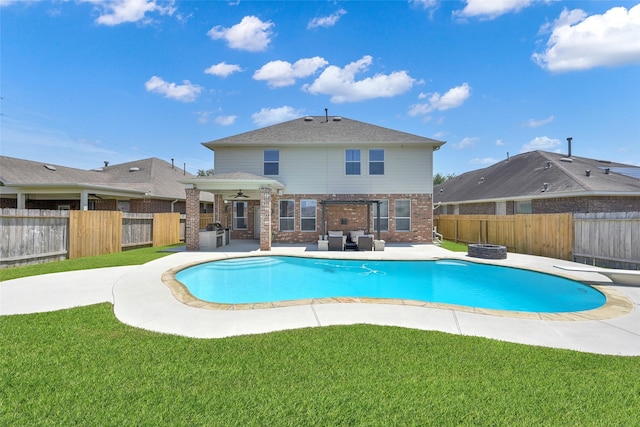 view of swimming pool with a lawn, an outdoor living space, ceiling fan, and a patio