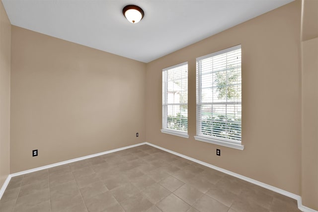 spare room featuring light tile patterned floors