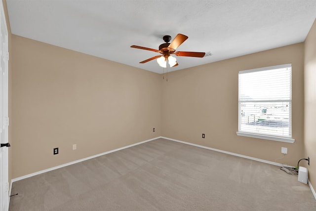 carpeted spare room with ceiling fan and a healthy amount of sunlight