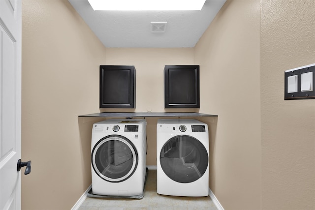 washroom featuring washing machine and dryer and light tile patterned floors