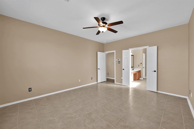 unfurnished bedroom with ceiling fan, light tile patterned flooring, and connected bathroom