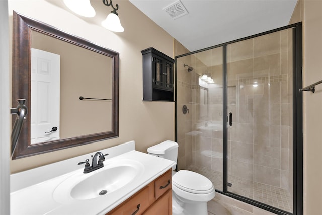 bathroom featuring a shower with door, vanity, and toilet