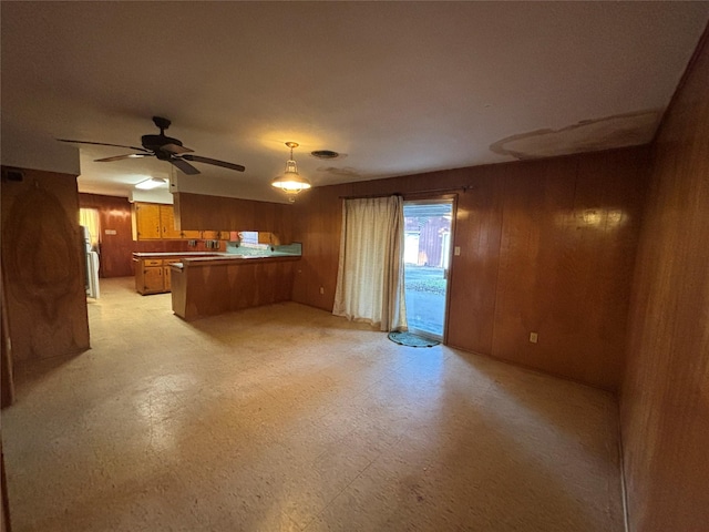 6402 Jim St, Houston, TX 77092 - unfurnished living room featuring wooden walls, light floors, and ceiling fan