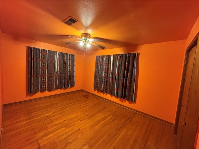 unfurnished room with ceiling fan, hardwood / wood-style floors, and a textured ceiling