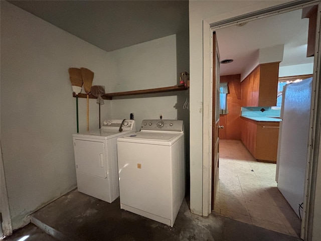 clothes washing area featuring washer and dryer