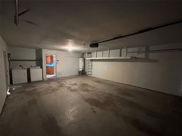 garage featuring water heater, washer and dryer, and a garage door opener