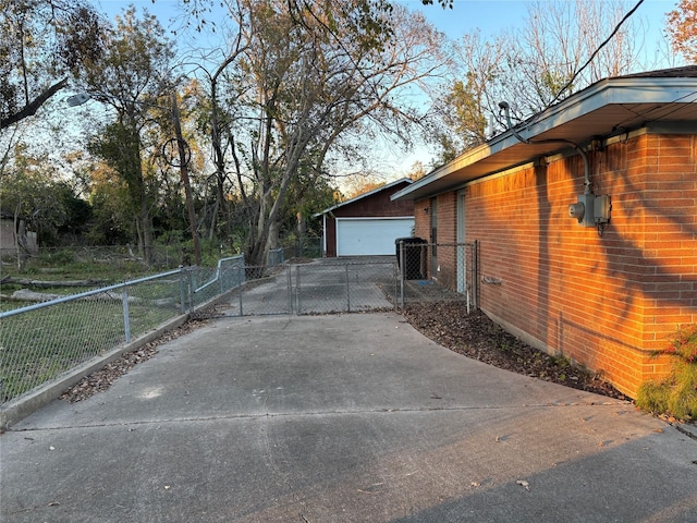 6402 Jim St, Houston, TX 77092 - view of property exterior featuring a gate, a detached garage, an outbuilding, and brick siding