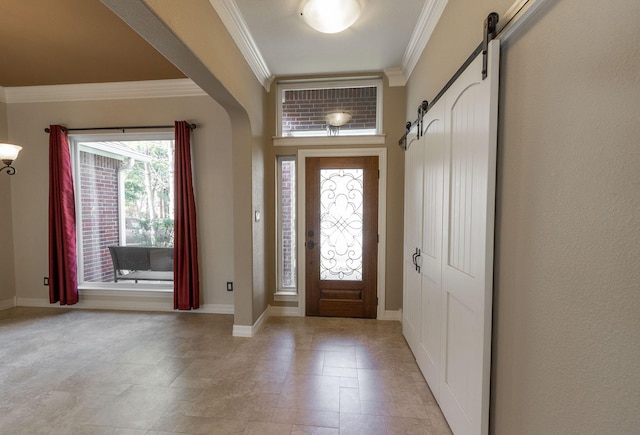 entrance foyer featuring a barn door and ornamental molding