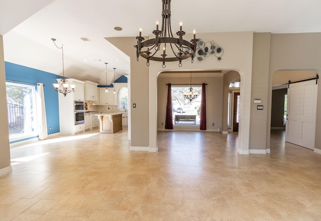 unfurnished living room featuring a barn door