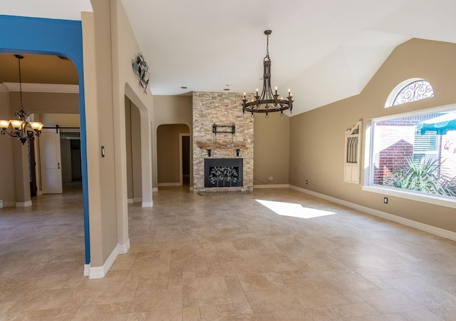 unfurnished living room featuring a fireplace and a notable chandelier