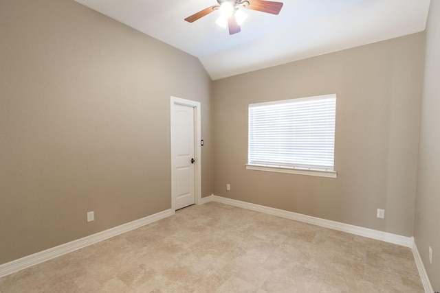 empty room with ceiling fan and lofted ceiling