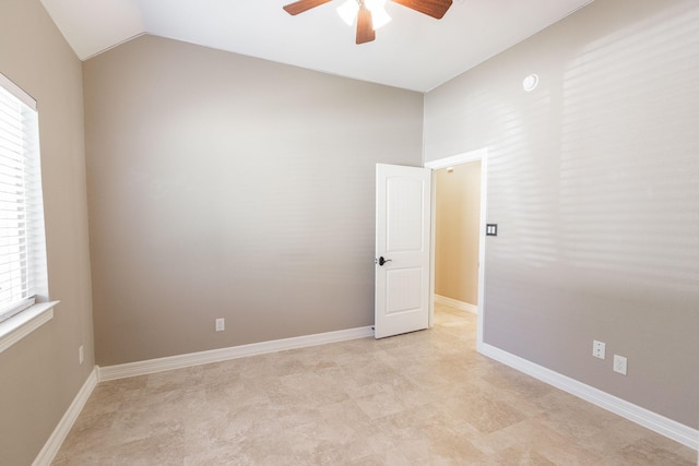 spare room with vaulted ceiling, plenty of natural light, and ceiling fan