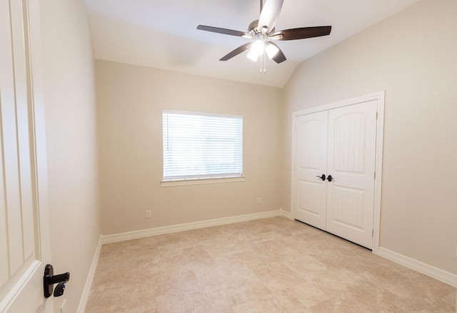 unfurnished bedroom featuring ceiling fan, lofted ceiling, and a closet